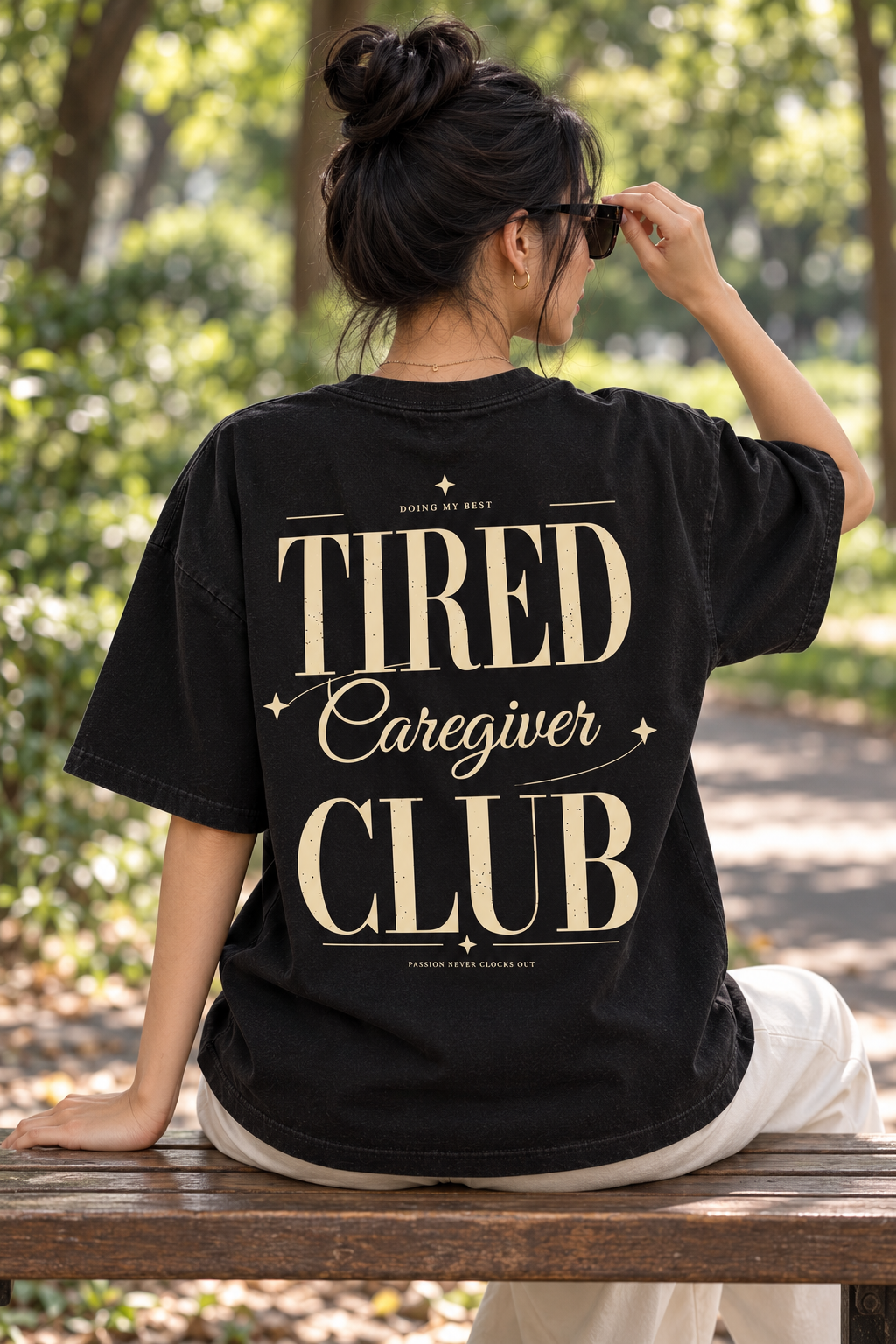 Tired Caregiver Club — T-shirt noir porté de dos, mockup lifestyle